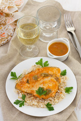 fish with sauce and boiled rice and glass of wine