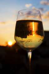 glass of wine in front of sunset
