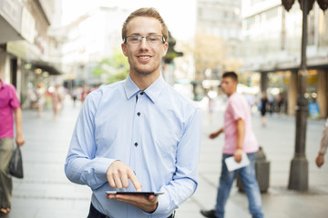 Businessman With Tablet Computer on street