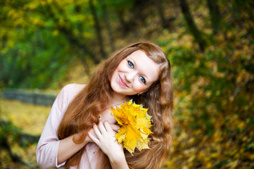 Redhead girl in autumn park
