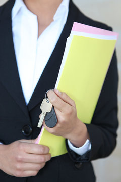 Businesswoman with files and keys