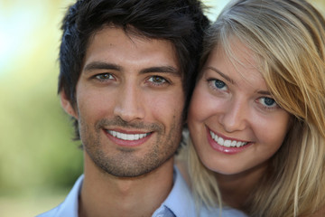 Young couple hugging outdoors