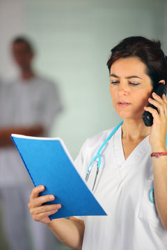 Nurse on the phone with a chart