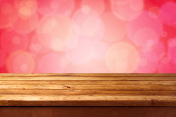Beautiful pink bokeh background with wooden table