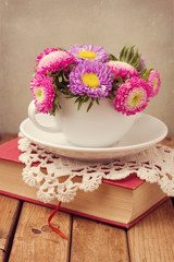 Vintage romantic still life with flowers and book