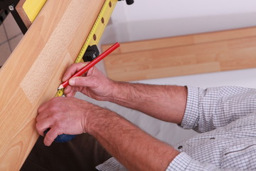 Carpenter measuring wood