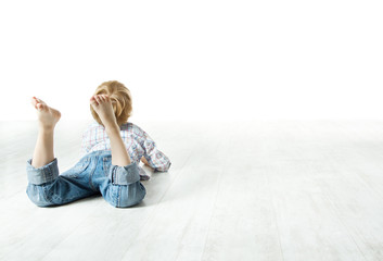 Child  back lying down on floor and looking forward