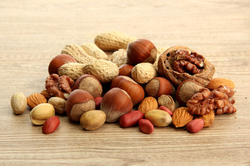 assortment of tasty nuts on wooden background