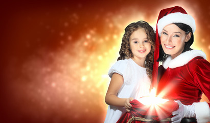 Little girl with christmas gifts and santa