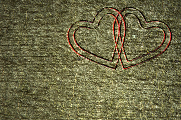 Two red hearts carved in a tree bark
