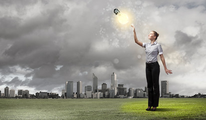 Businessman holding light bulb