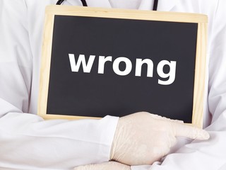 Doctor shows information on blackboard: wrong