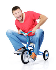 Curious man on a children's bicycle on white background