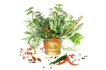 Mixed herbs with red hot peper in mortar with pestle on white ba