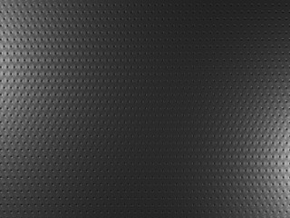 Black metal background with round holes