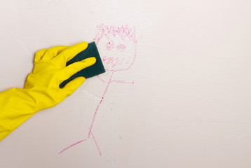cleaning crayon off wall with sponge