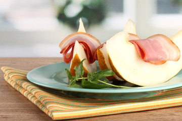 parma ham and melon, on wooden table