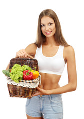 beautiful young woman with vegetables in basket, isolated