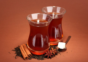glasses of Turkish tea, on brown background