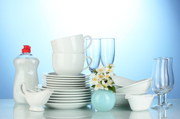 empty clean plates, glasses and cups with dishwashing liquid