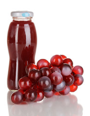 Delicious grapes juice in glass bottle and pink grapes next to