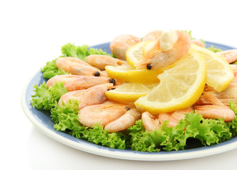 Boiled shrimps with lemon and lettuce leaves