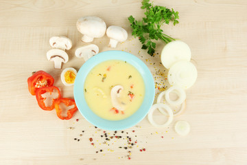 Fragrant soup in blue bowl with ingredients around