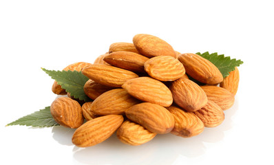 tasty almonds nuts with leaves, isolated on white