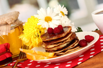 delicious sweet pancakes on bright background