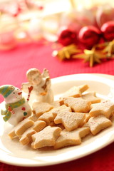 Christmas cookies and ornaments on red background