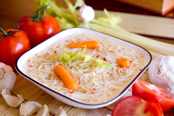 Chicken soup with cook books and vegetable
