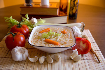Chicken soup with cook books and vegetable