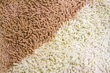 A beige carpet texture, close-up