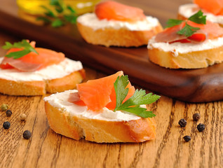 Sandwiches with a trout on a brown table