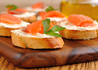 Sandwiches with a salmon on a brown table