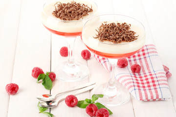 fruit jelly with berries in glasses on wooden table