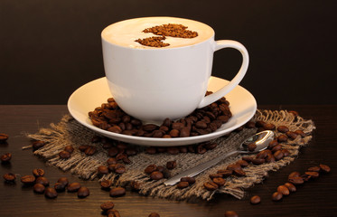 Latte on wooden table on brown background
