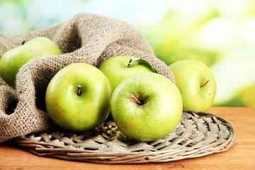 Ripe green apples with leaves