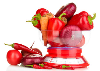 fresh red vegetables in scales isolated on white