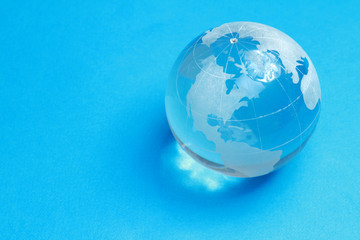 A glass globe, isolated on blue background