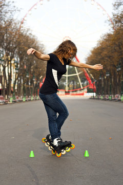 Young girl roller skates in the park