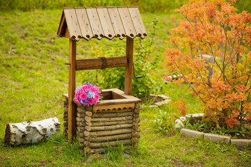 Coutryside autumn view with wedding bouquet on the well