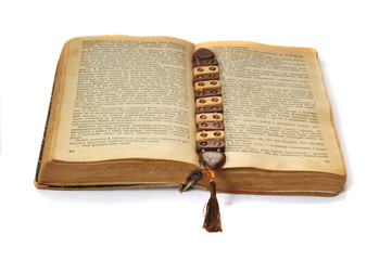 Opened old Ukrainian book with a bookmark on a white background