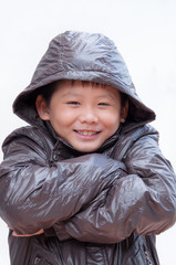 Smiling little asian boy in winter coat.