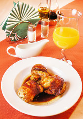 Quail carcasses stuffed with rice on a laid table