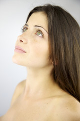 Beautiful naked woman looking up in the sky