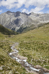 Fototapeta premium Creek in high mountain valley, Austrian/Italian Alps.