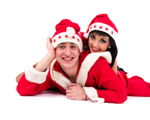 Happy young couple wearing santa claus clothes