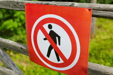 Prohibition sign on a wooden fence