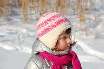 Fototapeta na wymiar Little girl winter portrait. Happy kid having fun with snow